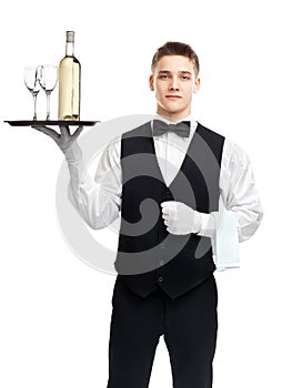Young waiter with bottle of wine on tray