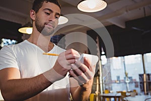 Young waiter taking order