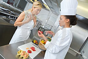 young waitress and chef fighting in kitchen