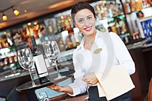 Young waitress at service in restaurant