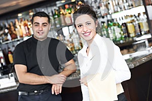 Young waitress at service in restaurant