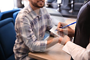 Young waitress taking an order from man in restaurant
