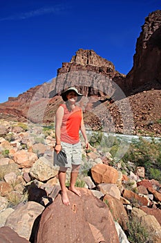 Young waoman backpacker by Hance Rapids in the Grand Canyon.