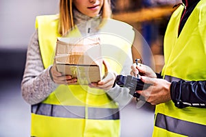 Young warehouse workers working together.