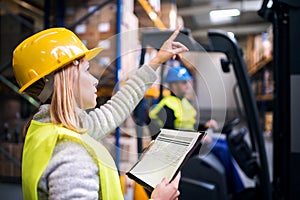 Young warehouse workers working together.