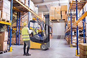 Young warehouse workers working together.