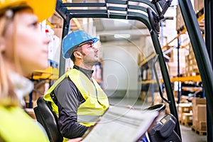 Young warehouse workers working together.