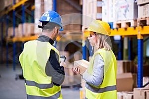 Young warehouse workers working together.