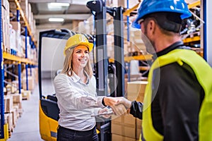 Young warehouse workers working together.