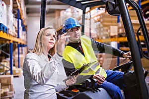 Young warehouse workers working together.