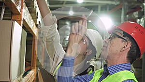 Young warehouse workers working together.