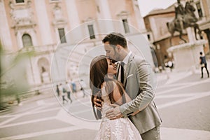 Young wedding couple on Capitoline hill in Rome