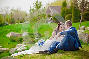 Young wedding couple enjoying romantic moments outside on a summer meadow