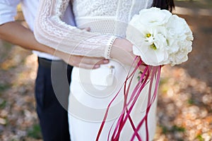 Young wedding couple enjoying romantic moments outside on a summer meadow