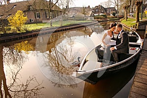 Young wedding couple posing on the boat