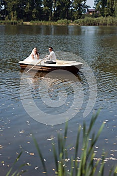 Young wedding couple sailing on the boat
