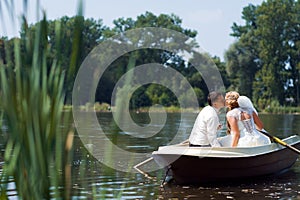 Young wedding couple sailing on the boat