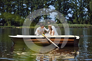 Young wedding couple sailing on the boat