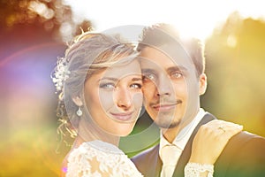 Young wedding couple on summer meadow