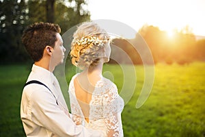 Young wedding couple on summer meadow