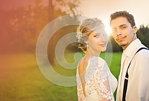 Young wedding couple on summer meadow