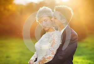 Young wedding couple on summer meadow