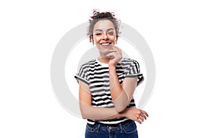 young well-groomed curly woman with black hair in a summer t-shirt smiles with teeth