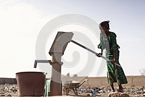 Young West Africa Woman Carrying Natural Water in a village