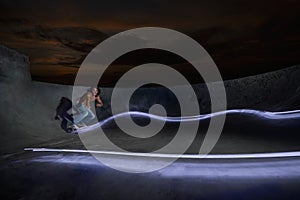 Shot of a guy skateboarding in a night skate park