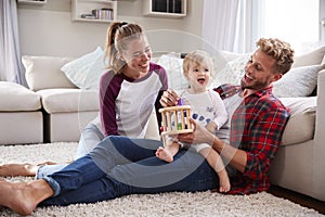 Young white family playing together in sitting room