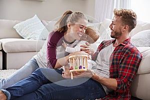 Young white family playing together in sitting room