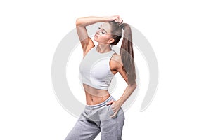 Young white fitness woman wearing sportswear standing over white wall background. Fitness concept