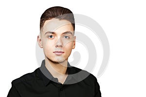 Young white guy with a pompadour hairstyle dressed in black shirt with a serious face isolated on white background photo