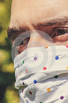 Young white man with a fabric handmade face mask during pandemic; COVID-19 outbreak. protection