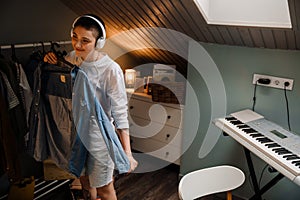 Young white woman in headphones smiling and listening music