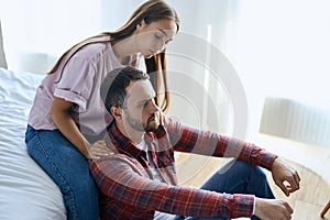 Young wife supporting upset husband