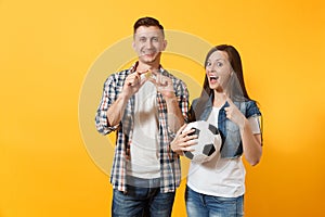 Young win couple, woman man, football fans holding bitcoin, metal golden coin, soccer ball, cheer up support team