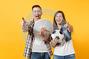 Young win couple, woman man, football fans holding bundle of dollars, cash money, soccer ball, cheer up support team