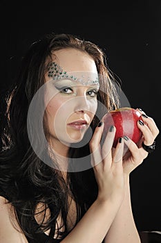 Young witch with red apple