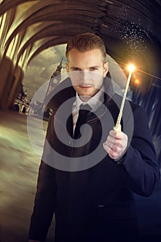 Young wizard holding a magic wand