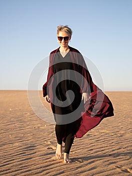 Young woman with abaya in the Salisil desert in Saudi Arabia photo