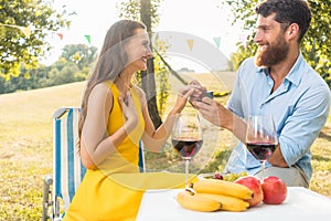 Young woman accepting with joy and emotion the marriage proposal