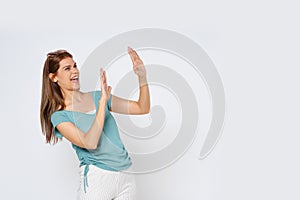 Young woman act like a pushing something isolated on white background. Surprised happy woman looking copy space in excitement.