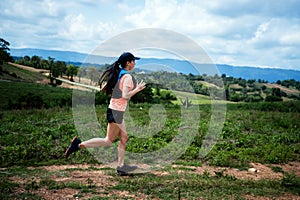 Young women active trail runners the top of a mountain in the afternoon, ultra marathon runners adventuring outdoors photo