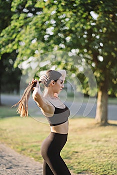 Young woman in activewear exercising outdoors