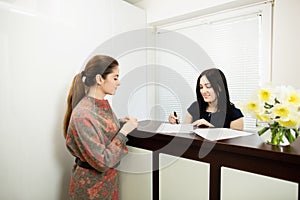 Young woman administrator in a dental clinic in the workplace. Admission of the client