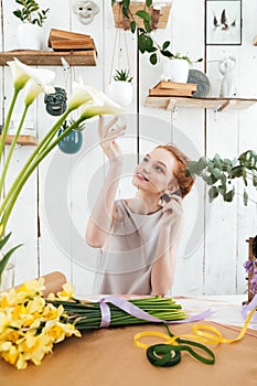 Young woman admire the beautiful flowers in workshop