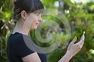 Young woman admires new cell phone