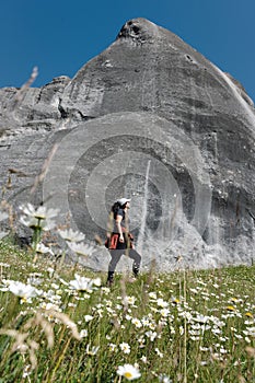 Young woman admiring big rock in Castle Hill. Narnia Movie set in New Zealand photo