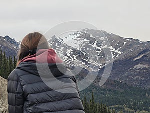 Young woman admiring the majestic view of the surrounding peaks